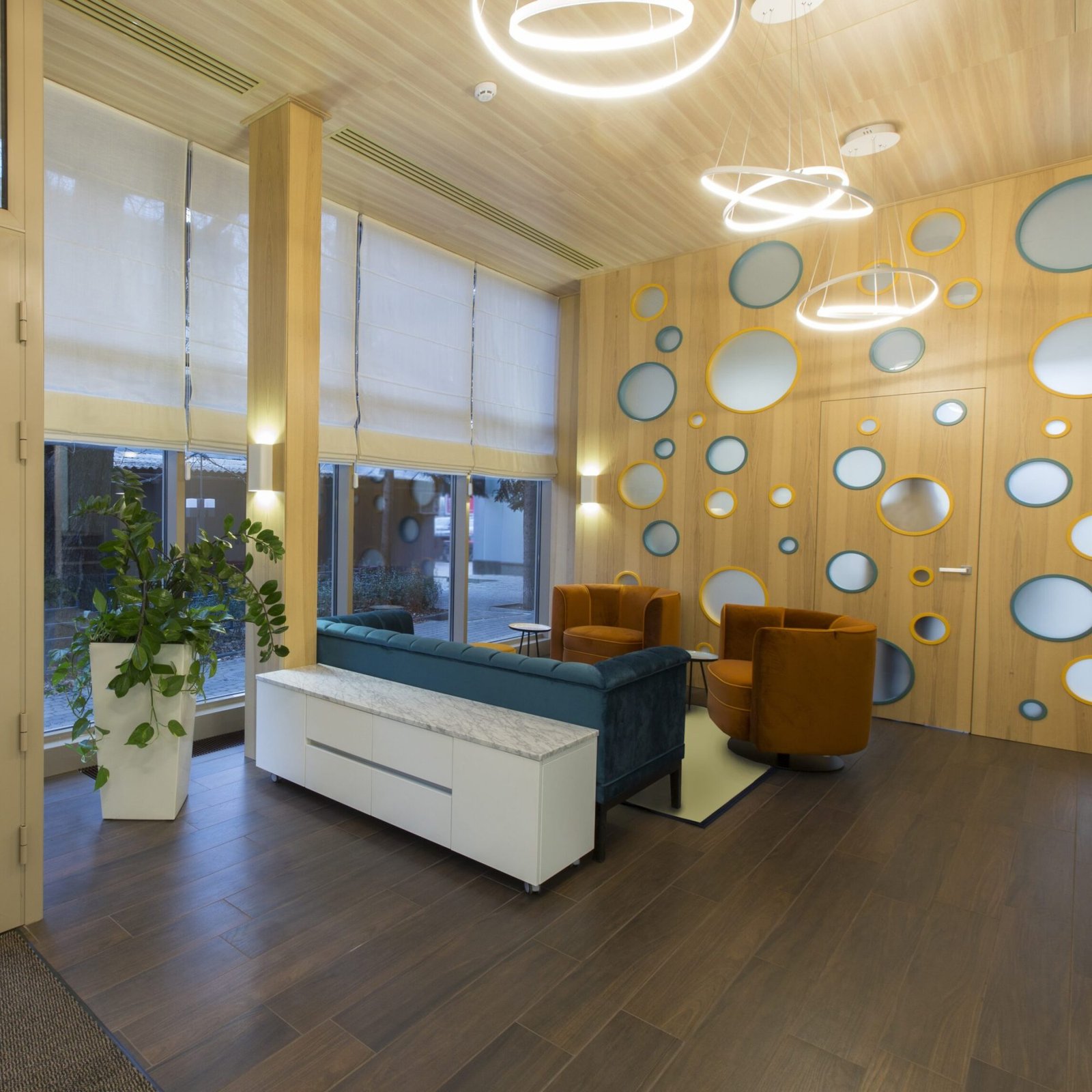 Entrance to the children dentistry, the waiting area and wall with round mirrors, copy space